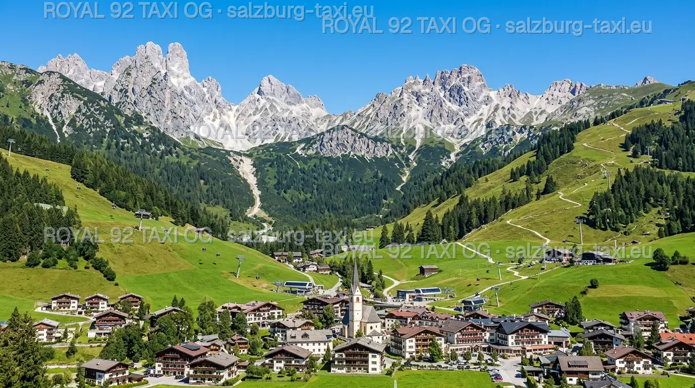 Flachau Alpine village below green ski slopes and rugged Salzburg mountain peaks